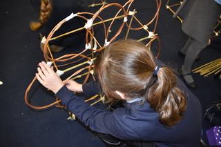 child constructing willow lantern