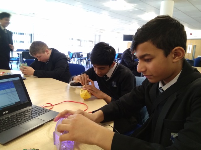 3 teens building data driven lanterns out of laser cut paper designs