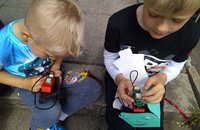 2 young boys showing their air quality projects