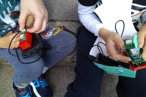 2 children holding aq iot projects